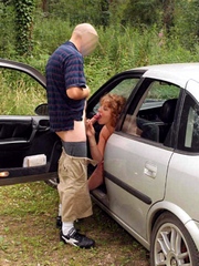 Redhead mom sucks guy dick in the car